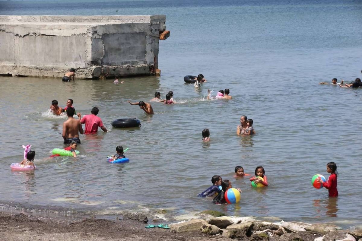 HEAT BUSTER Children swim at a beach in Noveleta, Cavite on Saturday, April 20, 2024 to escape the hot weather. PHOTOS BY RENE H. DILAN