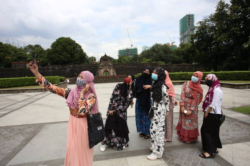 Local tourists take a group selfie in Fort Santiago in Intramuros, Manila on October 23, 2021. PHOTO BY RENE H. DILAN