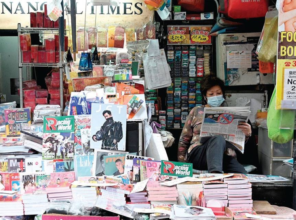 UNDER FIRE This photo taken on Jan. 6, 2022 shows a vendor reading a newspaper at a newsstand in Hong Kong. China’s crackdown on dissent has silenced or jailed most Hong Kong democracy activists and has now begun to focus on the press. AFP PHOTO