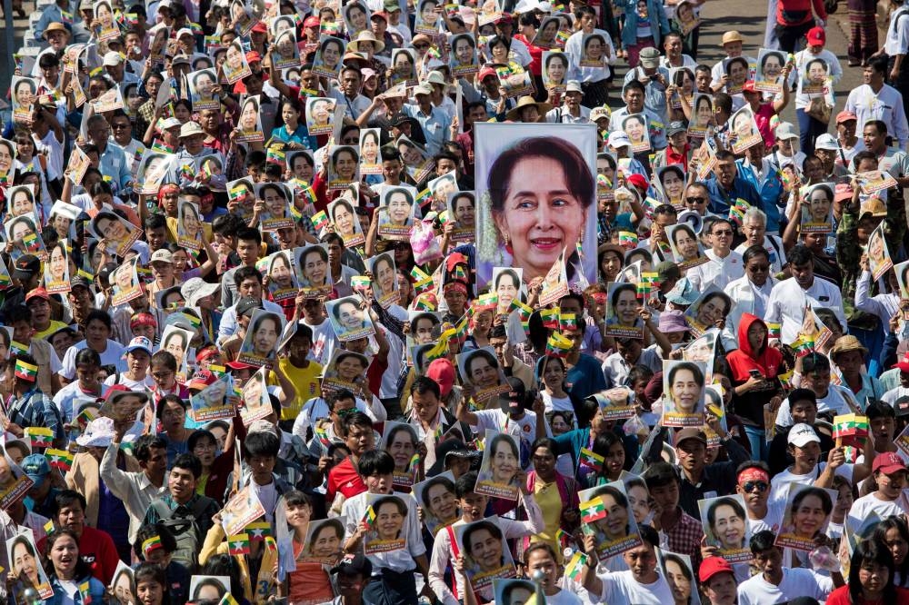 In this file photo taken on December 10, 2019, people participate in a rally in support of Myanmar's State Counsellor Aung San Suu Kyi, as she prepares to defend Myanmar at the International Court of Justice in The Hague against accusations of genocide against Rohingya Muslims, in Yangon. - Myanmar's junta has charged Aung San Suu Kyi with influencing election officials during 2020 polls, a source said on January 31, 2022, a year after it staged a coup alleging massive voter fraud. (Photo by AFP)