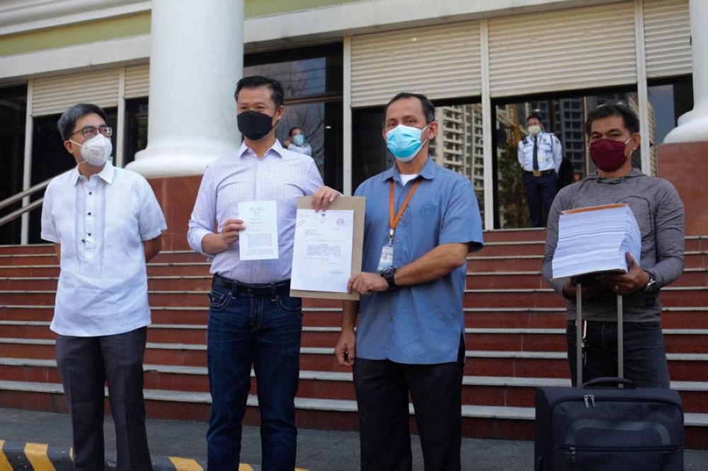 MALAMPAYA MAYHEM Sen. Sherwin Gatchalian and the Senate Secretariat-Records Management and Mailing Service hold the transmittal letter on the filing of criminal and administrative charges before the Office of the Ombudsman in Quezon City on Friday, Feb. 4, 2022 against Energy Secretary Alfonso Cusi and some of his officials over the alleged questionable sale of a majority stake in the Malampaya gas field. PHOTO BY JOHN ORVEN VERDOTE