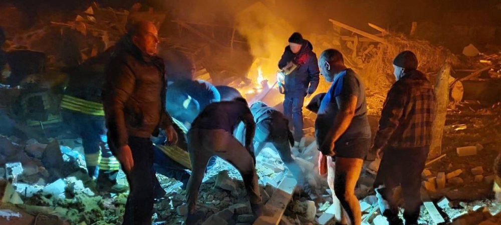 This handout image released by the State Emergency Service of Ukraine, shows rescuers working among the rubble of private houses, which is said were destroyed by a Russian airstrike, in Zhytomyr on March 1, 2022. AFP PHOTO / Ukraine Emergency Ministry press service / handout