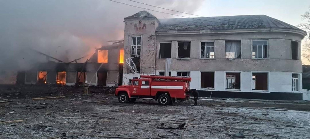 In this handout picture taken and released by the State Emergency Service of Ukraine on March 17, 2022, firemen work to extinguish a fire at an educational institution hit by shelling in the town of Merefa in the Kharkiv region. AFP PHOTO / State Emergency Service of Ukraine / handoutS