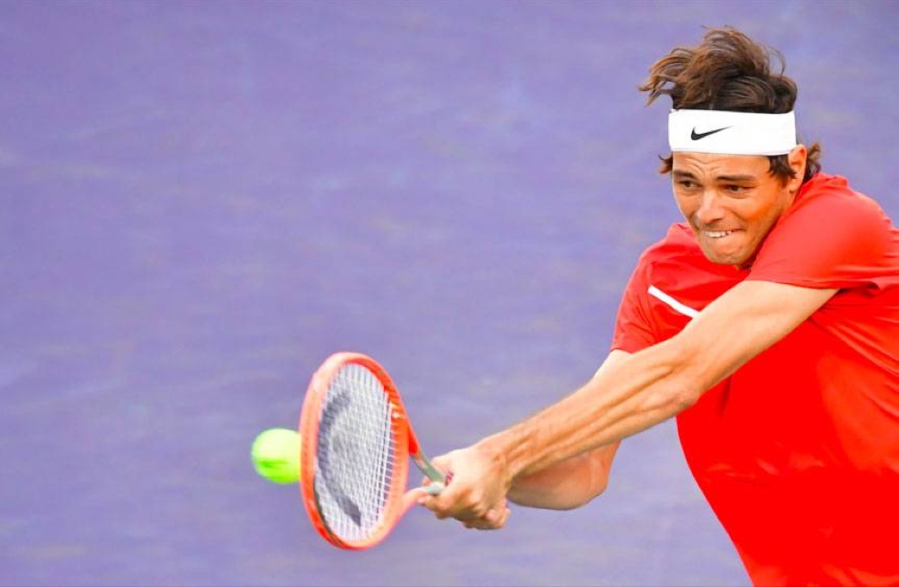 Taylor Fritz of the US hits a backhand return to Rafael Nadal of Spain in their ATP Men’s Final at the Indian Wells tennis tournament on Sunday, March 20, 2022 (March 21 in Manila), in Indian Wells, California. AFP PHOTO