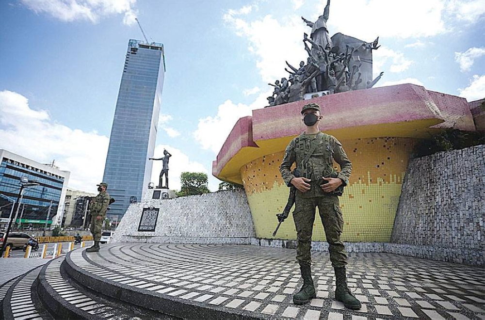 Members of the Philippine Army man their post at the EDSA People Power Monument on Thursday, May 12 2022, as part of the contingency plan to keep the peace after the elections. PHOTO BY JOHN ORVEN VERDOTE