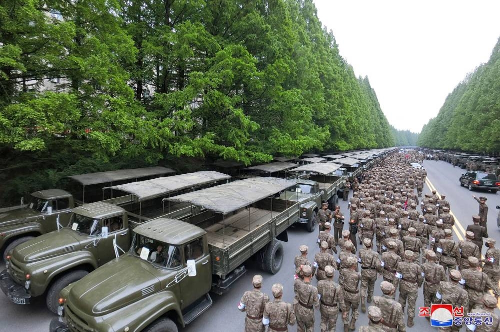 This picture taken on May 16, 2022 and released from North Korea's official Korean Central News Agency (KCNA) on May 17 shows officers of the military medical field of the Korean People's Army going to supply medicines to resolve the epidemic prevention crisis over the spread of Covid-19 coronavirus, in Pyongyang. AFP PHOTO/KCNA VIA KNS