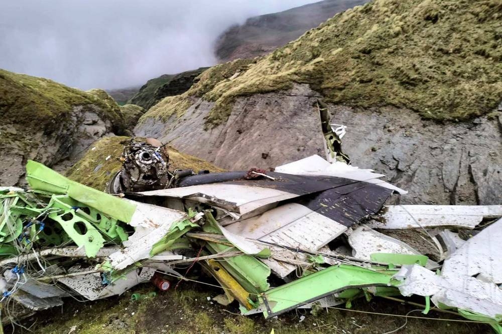 This handout photograph taken on May 30, 2022 and released by the Nepal Police shows the wreckage of a Twin Otter aircraft, operated by Nepali carrier Tara Air, laying on a mountainside in Mustang, a day after it crashed. AFP PHOTO/Nepal Police