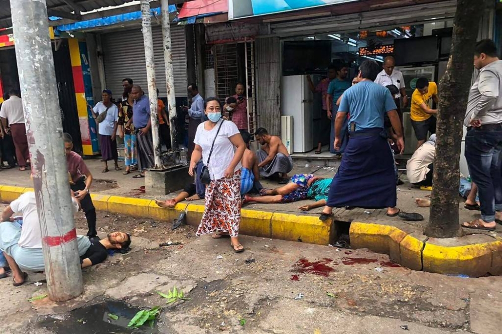 AGHAST OVER BLAST This photo taken and obtained from the Facebook account of Aung Khaing Thein on Tuesday, May 31, 2022 shows passersby helping people injured after a bomb blast in Yangon. AUNG KHAING THEIN FACEBOOK ACCOUNT PHOTO VIA AFP