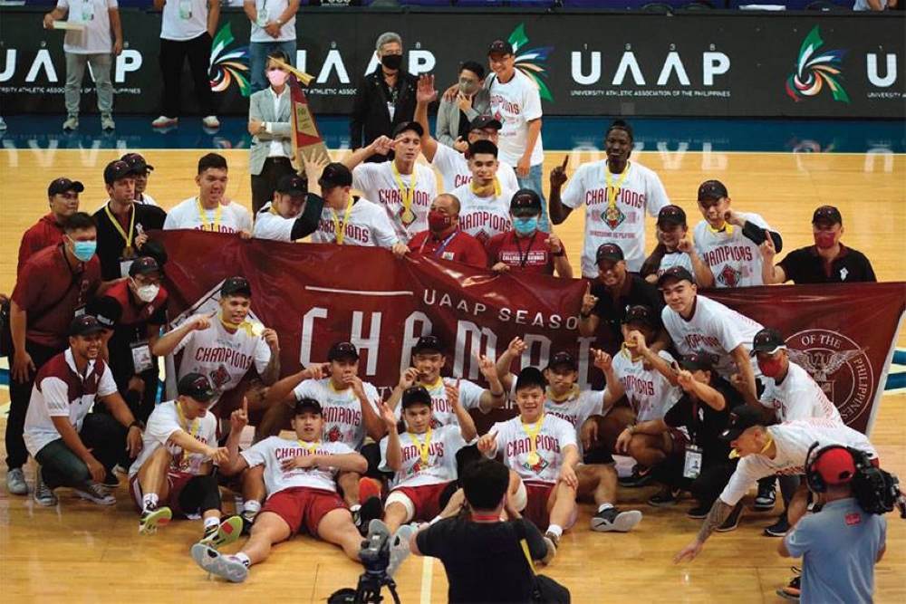 This May 13, 2022 file photo shows the University of the Philippines Fighting Maroons basketball team celebrating their winning the University Athletic Association of the Philippines (UAAP) Season 84 championship match at the SM Mall of Asia Arena in Pasay City. PHOTO BY J. GERARD SEGUIA