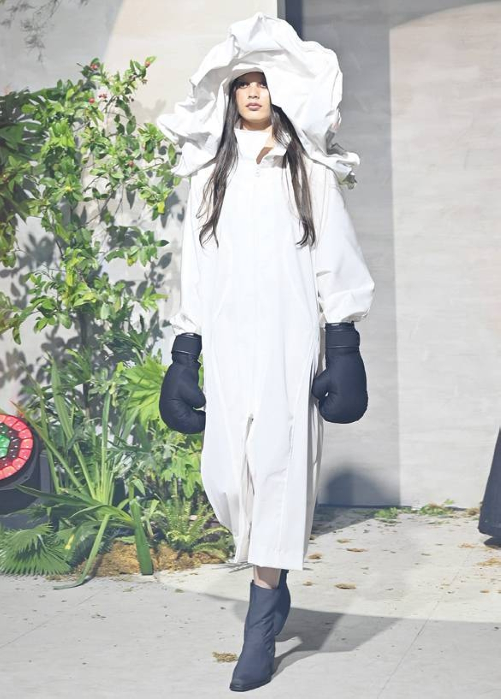 Breaking the dark and gloomy ensemble was a single white dress that formed a cloud-like hood on top.