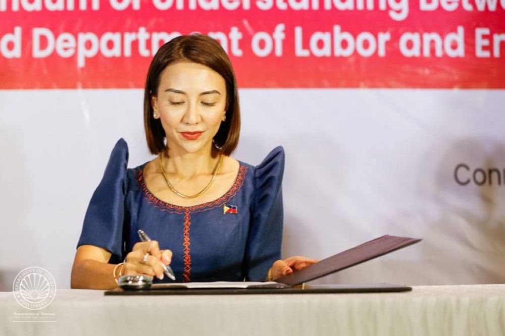 Department of Tourism Secretary Christina Garcia Frasco signs the memorandum of agreement with the Department of Labor and Employment on Aug. 30, 2022. CONTRIBUTED PHOTO