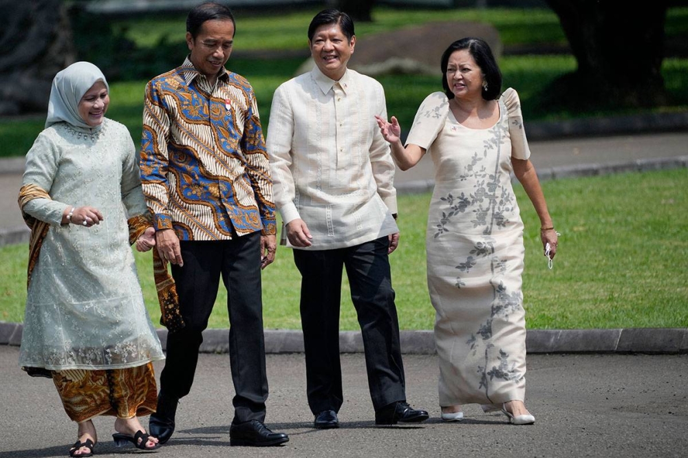 Philippine President Ferdinand Marcos Jr. (2nd R) and Philippine First Lady Louise Araneta Marcos (R) walk with Indonesian President Joko Widodo (2nd L) and Indonesian First Lady Iriana Widodo (L) after a tree-planting ceremony at the Presidential Palace in Bogor, West Java on September 5, 2022. Achmad Ibrahim / POOL / AFP