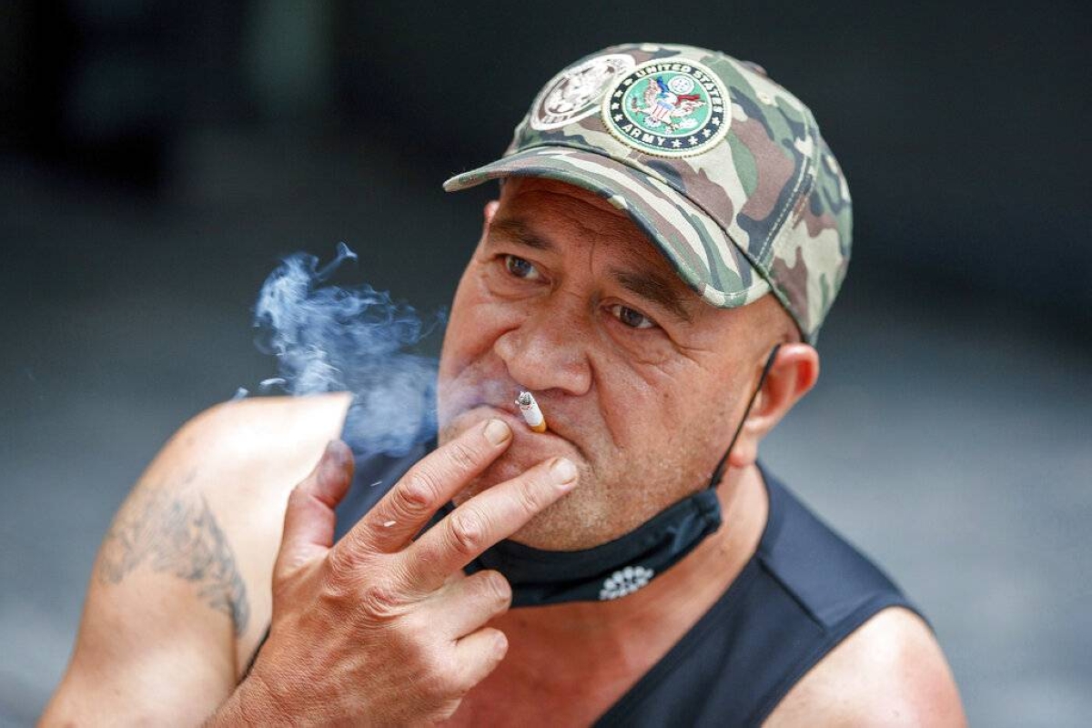 A man sits while smoking in the city of Auckland, New Zealand on Dec. 9, 2021. AP FILE PHOTO