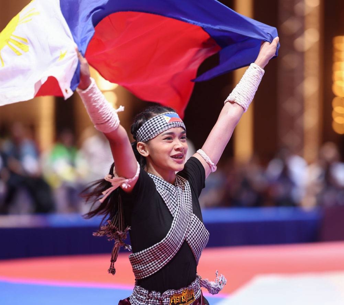 Angel Gwen Derla waves the Philippine flag after winning the gold medal in kun bokator, a traditional Cambodian sport, in the 32nd Southeast Asian Games on Thursday, May 4, here at the Chroy Changvar Convention Center Hall C. PHOTO BY RIO DELUVIO