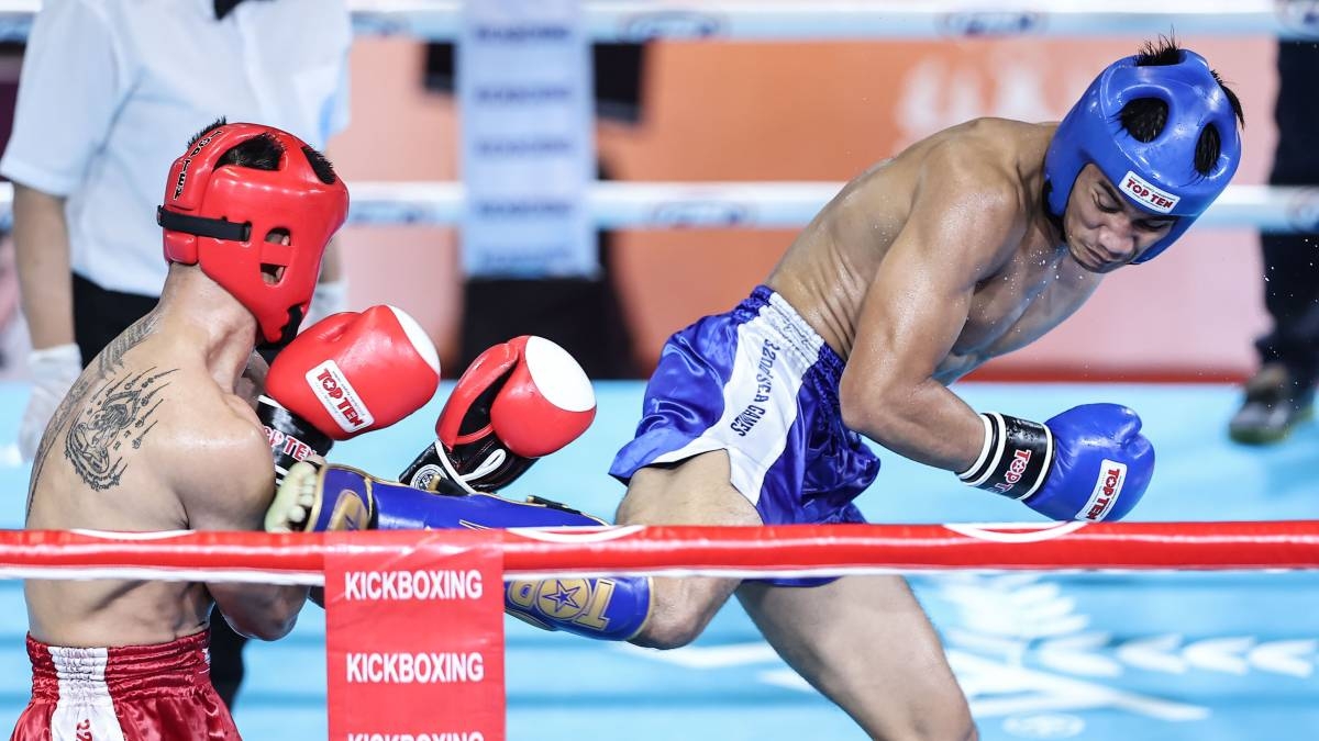 Filipino fighter Jean Claude Saclag (right) kicks Rakim San of Cambodia during the men’s -63.5-kg finals of the Southeast Asian Games kickboxing competitions on Monday, May 15 in Phnom Penh, Cambodia. PHOTO BY RIO DELUVIO
