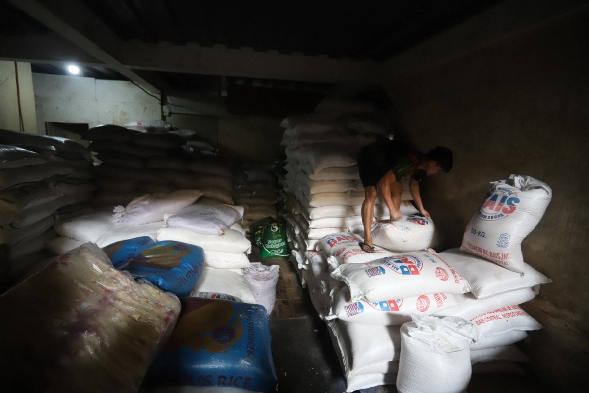 Worker stores sacks of sugar at retail store in Marikina | The Manila Times