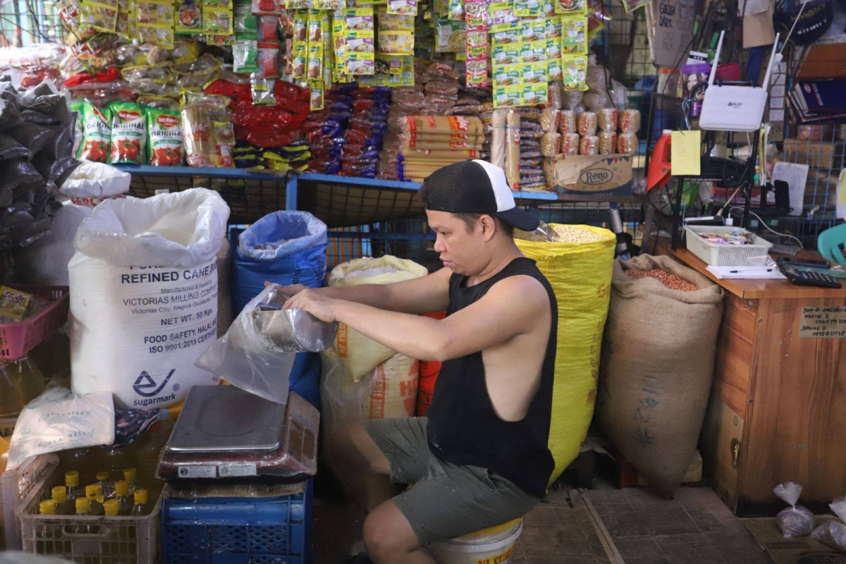 Worker stores sacks of sugar at retail store in Marikina | The Manila Times