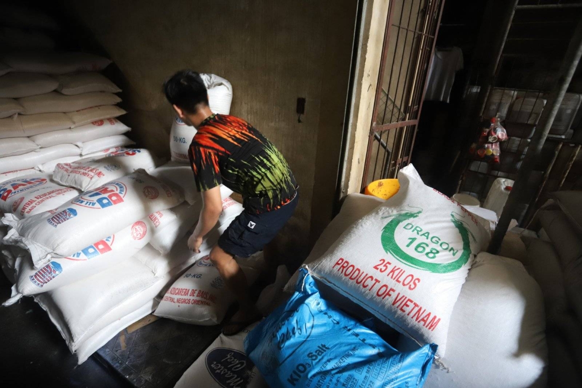 Worker stores sacks of sugar at retail store in Marikina | The Manila Times