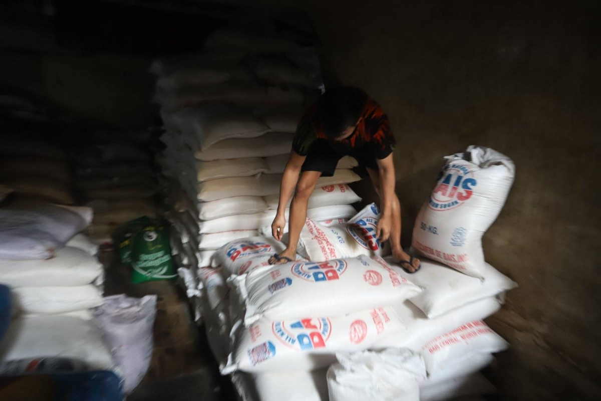 Worker stores sacks of sugar at retail store in Marikina | The Manila Times
