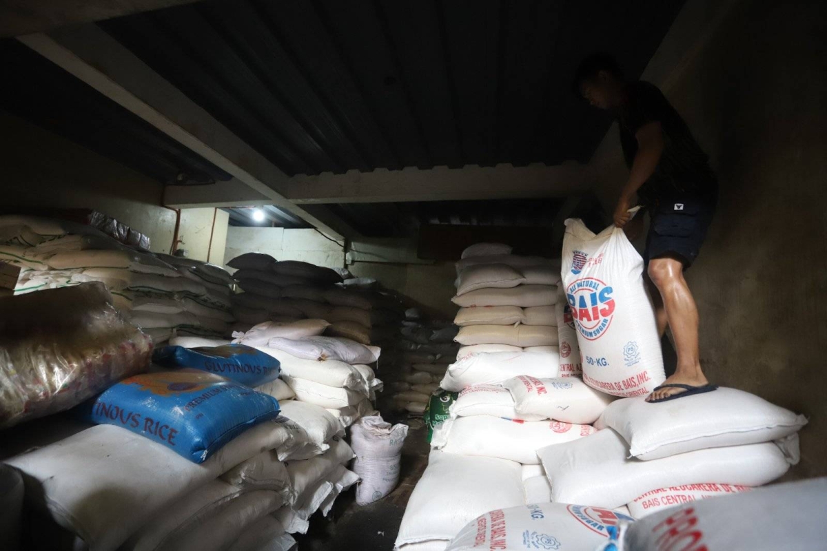Worker stores sacks of sugar at retail store in Marikina | The Manila Times