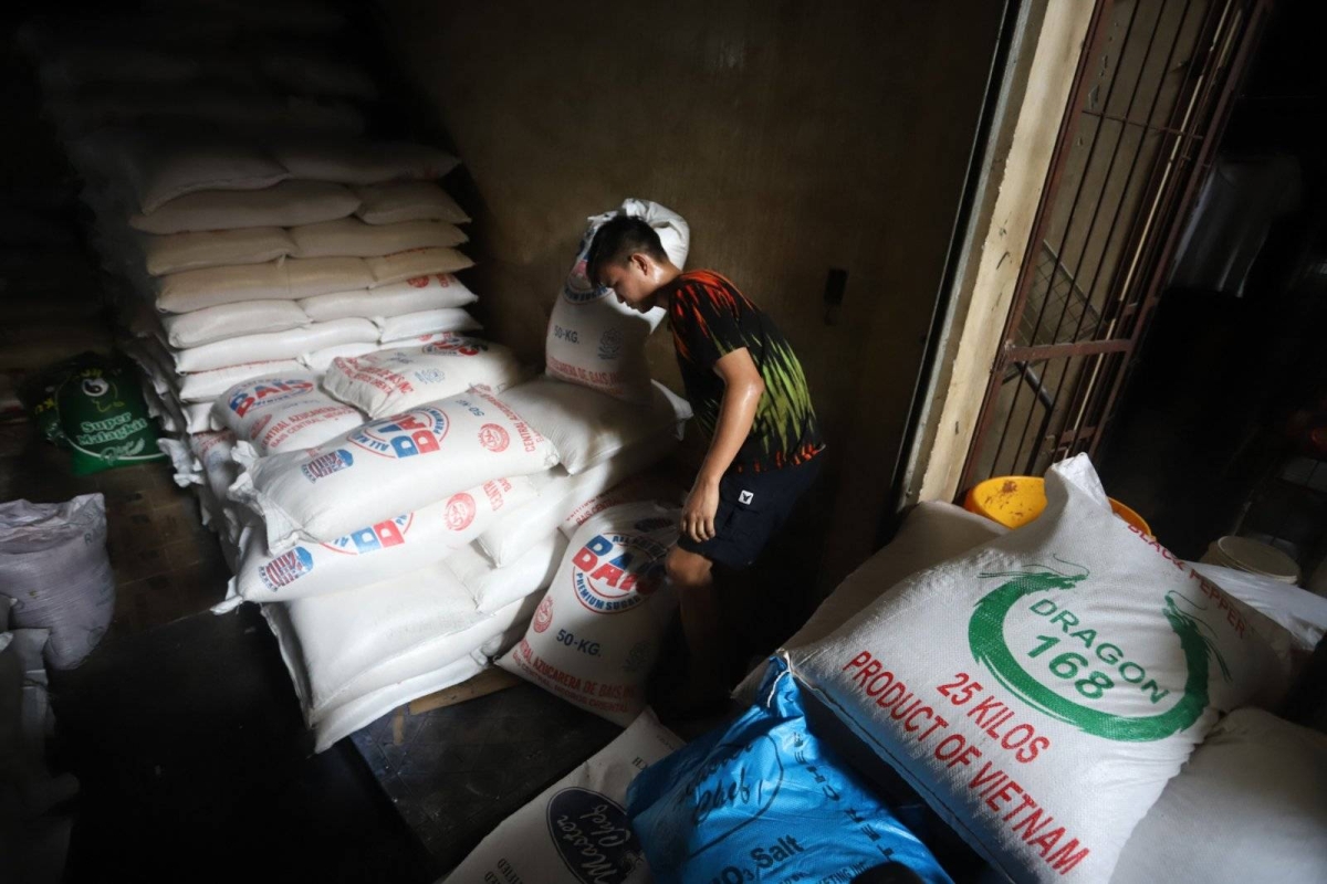 Worker stores sacks of sugar at retail store in Marikina | The Manila Times