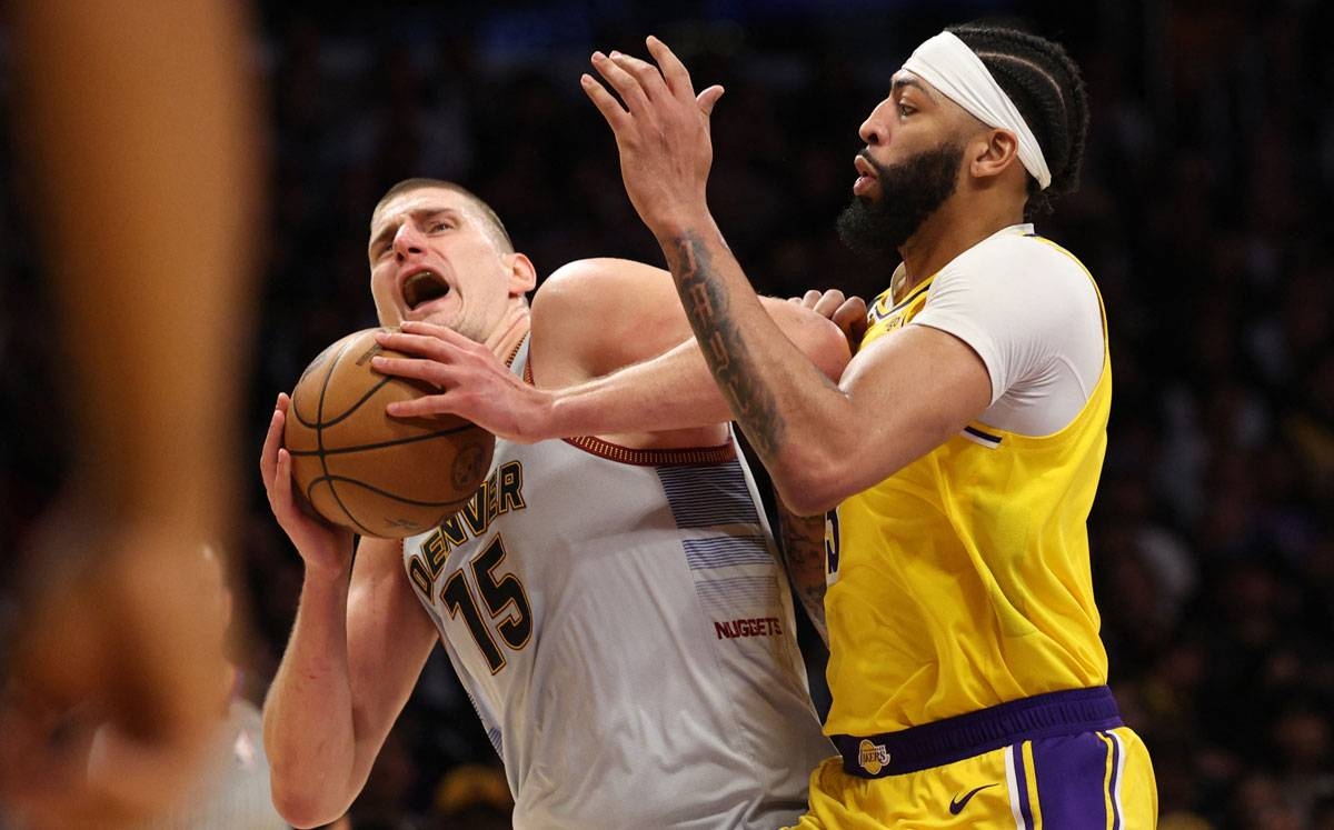 Nikola Jokic of the Denver Nuggets is fouled by Anthony Davis of the Los Angeles Lakers during the third quarter in game four of the Western Conference Finals at Crypto.com Arena on May 22, 2023 in Los Angeles, California. AFP PHOTO