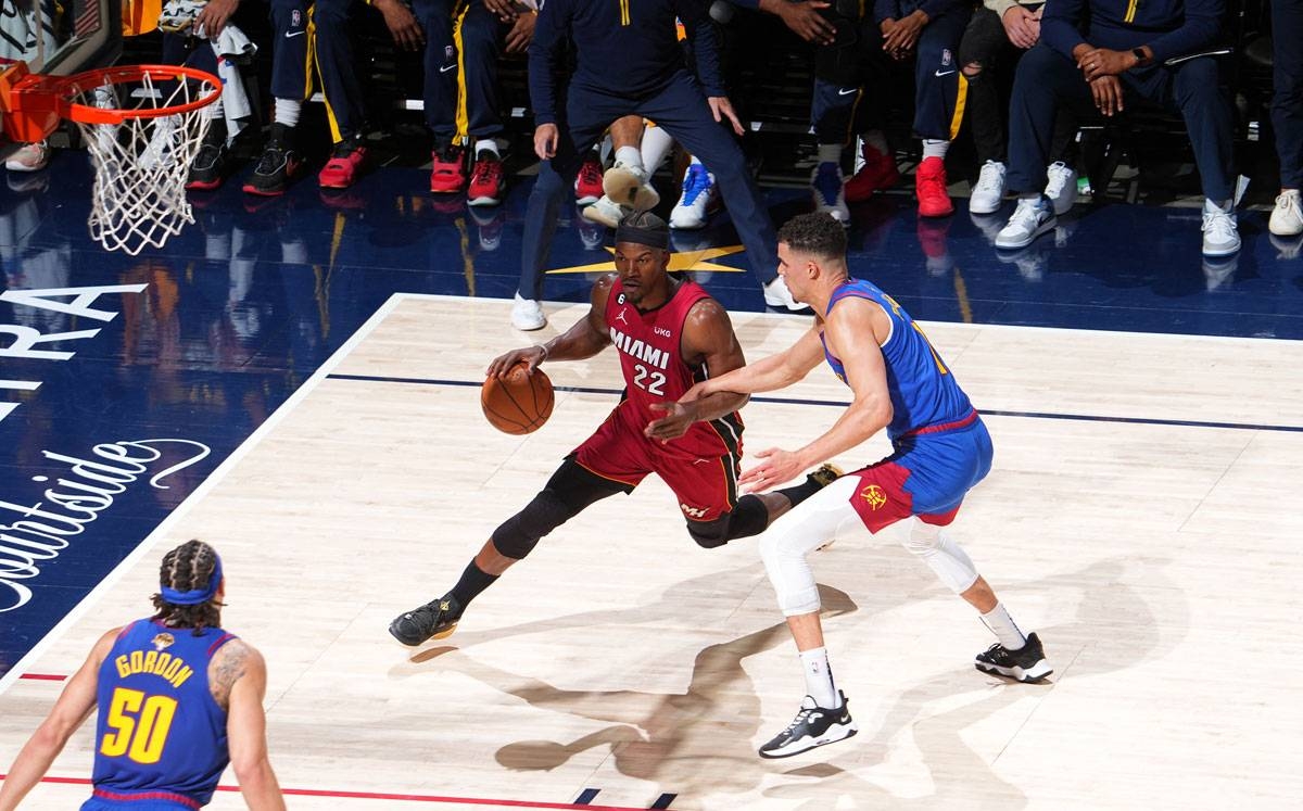 NUGGETS IN GAME ONE Jimmy Butler (22) of the Miami Heat handles the ball defended by Bruce Brown (11) during Game One of the 2023 NBA Finals on June 1, 2023 at the Ball Arena in Denver, Colorado. The Nuggets dominated the Heat, 104-93 in the first of their best-of-seven championship series. PHOTO BY AFP