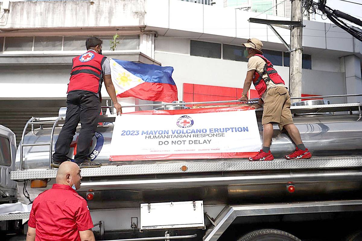 HELP ON THE WAY The Philippine Red Cross in Mandaluyong City sends trucks containing goods and equipment for residents in Albay, Bicol, who have been evacuated due to the increasing restiveness of Mayon Volcano. The Philippine Institute of Volcanology and Seismology has raised Alert Level 3 and said on Friday, June 9, 2023, that a ‘hazardous eruption’ was expected anytime. PHOTO BY JOHN ORVEN VERDOTE