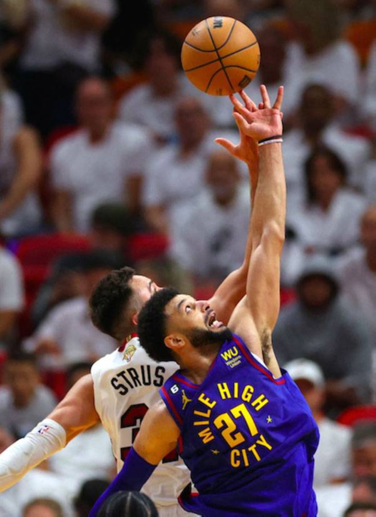 Jamal Murray of the Denver Nuggets tips off against Max Strus of the Miami Heat during the third quarter in Game 3 of the 2023 NBA Finals at Kaseya Center on Wednesday, June 7, 2023, in Miami, Florida. AFP PHOTO