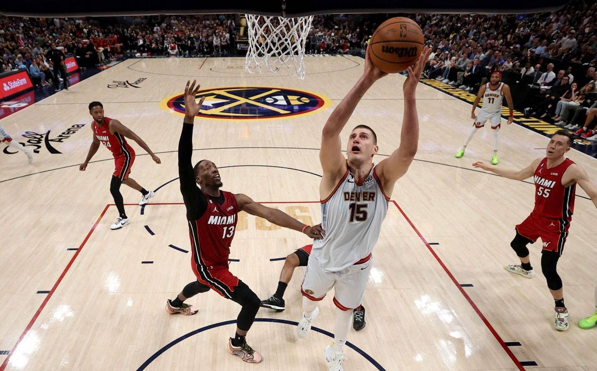 Nikola Jokic (15) of the Denver Nuggets drives to the basket against Bam Adebayo (13) of the Miami Heat during the second quarter in Game Five of the 2023 NBA Finals at Ball Arena on Monday, June 12, in Denver, Colorado (Tuesday, June 13, in Manila). PHOTO BY MATTHEW STOCKMAN / AFP