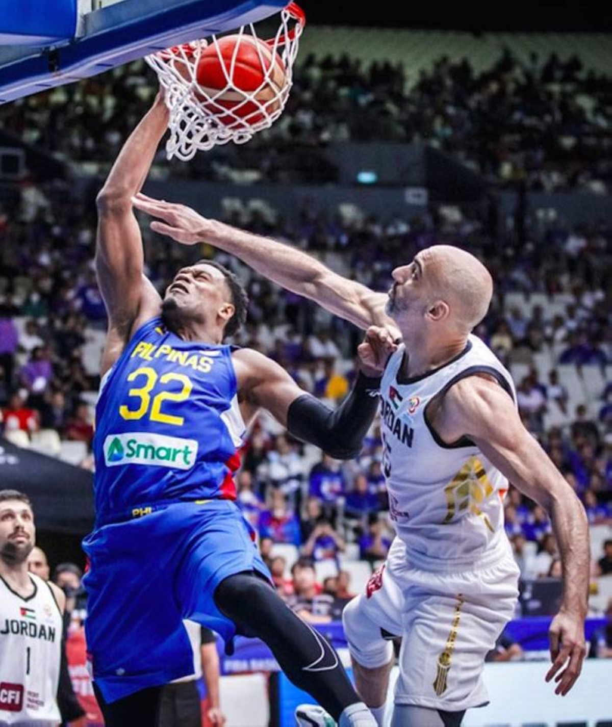 Naturalized player Justin Brownlee dunks against a Jordanian player during the FIBA World Cup Asian Qualifiers held at the Philippine Arena in February. FIBA PHOTO