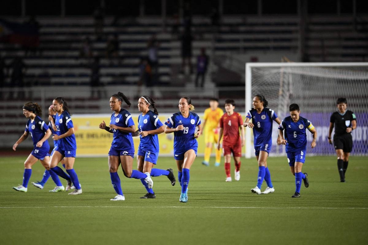 This photo taken on July 15, 2022 shows members of the Philippine women's football team on the pitch as they play against Vietnam in the women's Asian Football Federation semi-final match at Rizal Memorial Stadium in Manila. PHOTO BY TED ALJIBE/ AFP