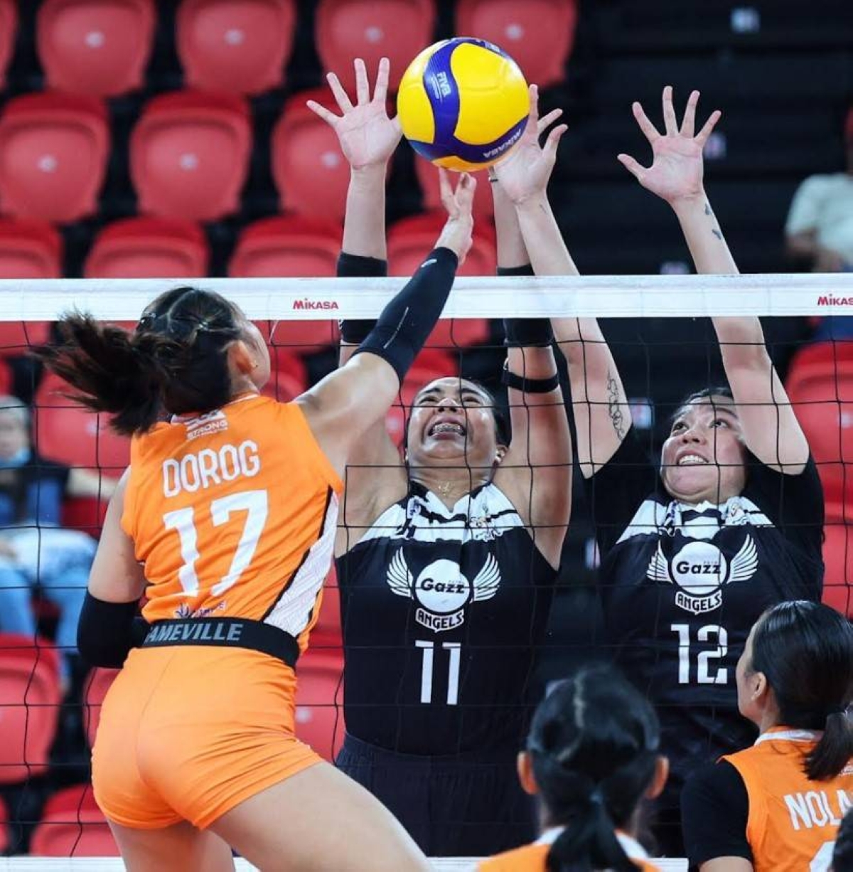 Marian Buitre (11) and KC Galdones (12) of Petro Gazz tried to deny the spike attempt of Jessa Dorog of Farm Fresh during their PVL Invitational Conference game at the PhilSports Arena on Tuesday, July 11. PHOTO BY RIO DELUVIO