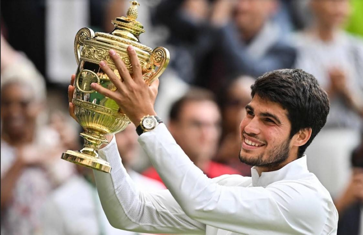 Spain's Carlos Alcaraz raises the winner's trophy after beating Serbia's Novak Djokovic during their men's singles final tennis match on the last day of the 2023 Wimbledon Championships at The All England Tennis Club in Wimbledon, southwest London, on Sunday, July 16 (Monday, July 17, in Manila). PHOTO BY GLYN KIRK / AFP