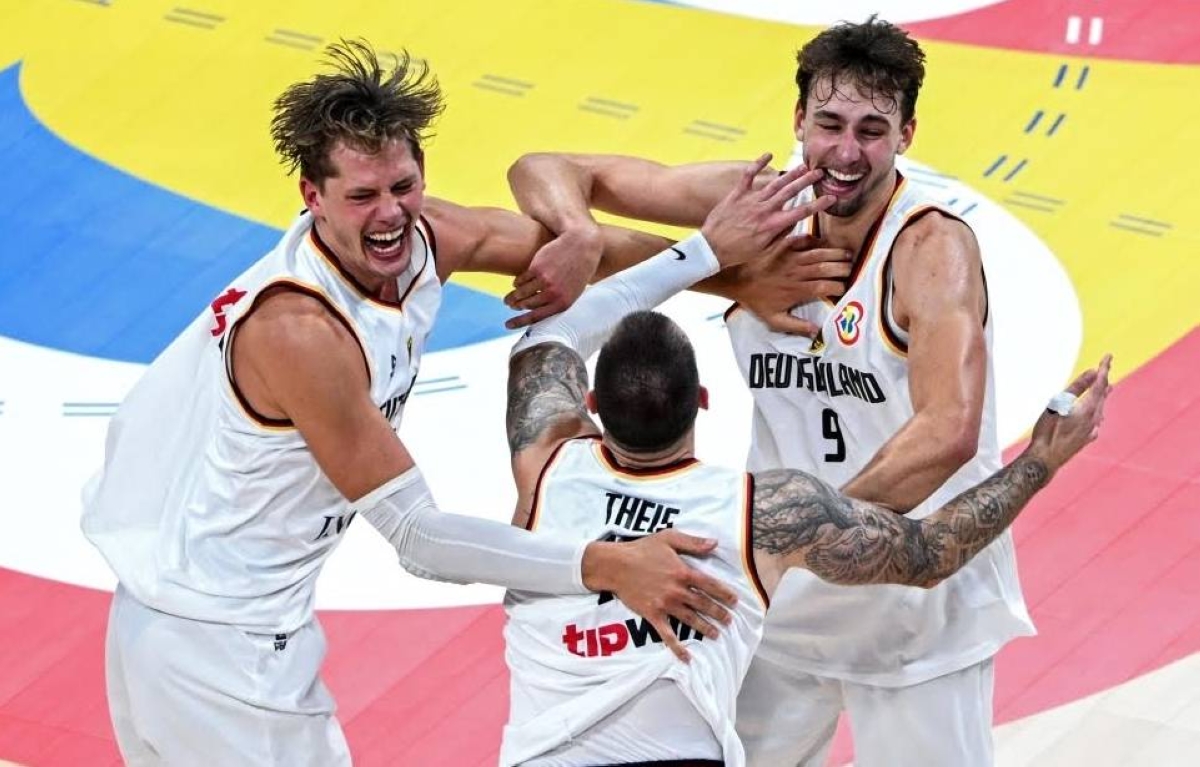 Germany's Moritz Wagner, Daniel Theis and Franz Wagner celebrate after winning the FIBA Basketball World Cup final game against Serbia in Manila on September 10, 2023. AFP PHOTO
