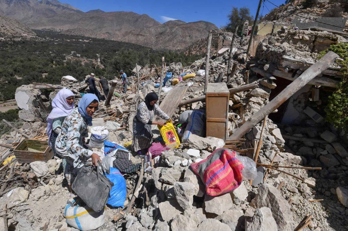 Residents salvage belongings from the rubble of Imoulas village in the Taroudant province, one of the most devastated in quake-hit Morocco, on September 11, 2023. Moroccan rescuers supported by newly-arrived foreign teams on September 11 faced an intensifying race against time to dig out any survivors from the rubble of mountain villages, on the third day after the country's strongest-ever earthquake. AFP PHOTO