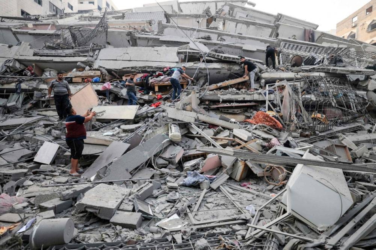 CRUSHED Residents salvage some belongings from a building that collapsed during an Israeli air strike in Gaza City early Sunday, Oct. 8, 2023. AFP PHOTO