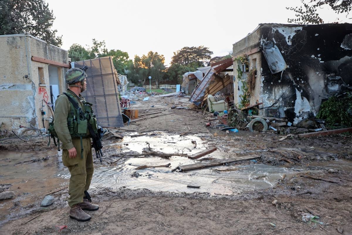 Israeli troops search the scene of a Palestinian militant attack in the Israeli kibbutz of Kfar Aza on the border with the Gaza Strip on October 11, 2023. Thousands have died and the toll continues to climb dramatically five days after Palestinian militants launched a surprise attack on Israel, which has responded with a massive bombardment of Gaza. GIL COHEN-MAGEN / AFP