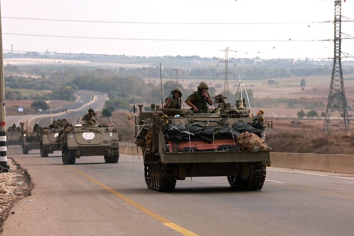Israeli soliders ride in their armoured vehicles towards the border with the Gaza Strip on October 16, 2023, amid the ongoing battles between Israel and the Palestinian group Hamas. Menahem KAHANA / AFP