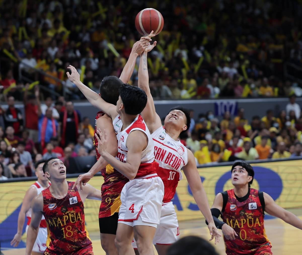 Mapua and San Beda battle for the rebound during the NCAA Season 99 men's basketball finals at the Mall of Asia Arena in Pasay on December 10, 2023. PHOTO BY RIO DELUVIO