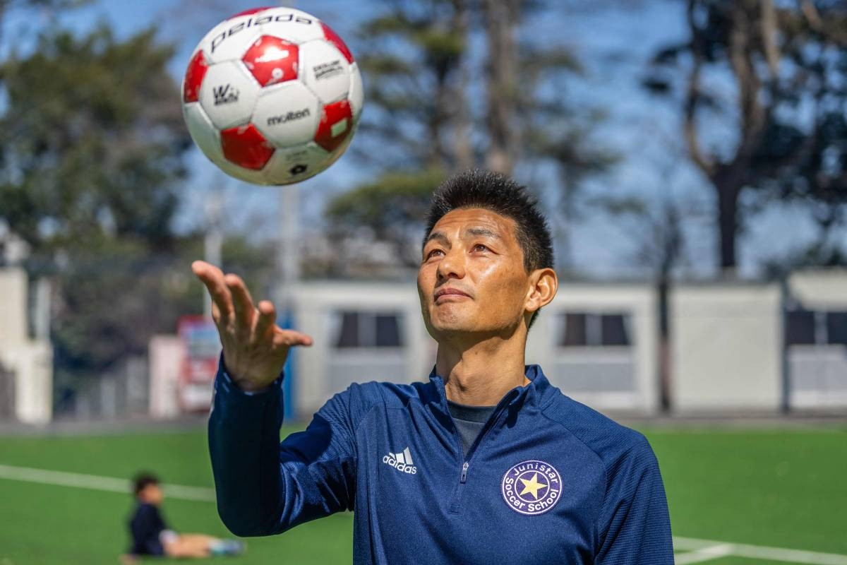 In this picture taken on March 14, 2024, former North Korean football player An Yong Hak poses for photos following an interview by AFP in Yokohama. An Yong Hak was born and raised in Japan but he will be cheering for his former team North Korea when the two sides clash in a World Cup qualifier in Tokyo on March 21. PHOTO BY YUICHI YAMAZAKI / AFP
) / To go with 'FBL-WC-PRK-JPN, INTERVIEW' by Andrew MCKIRDY