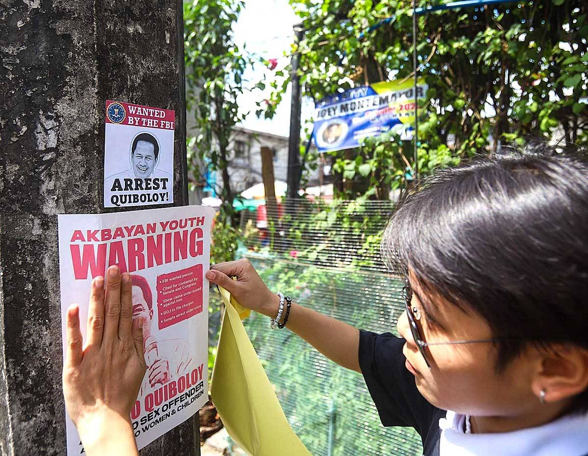 NO FAN A member of Akbayan Youth puts up posters calling for the arrest of Pastor Apollo Quiboloy in Quezon City on Monday, March 18, 2024. PHOTO BY JOHN ORVEN VERDOTE