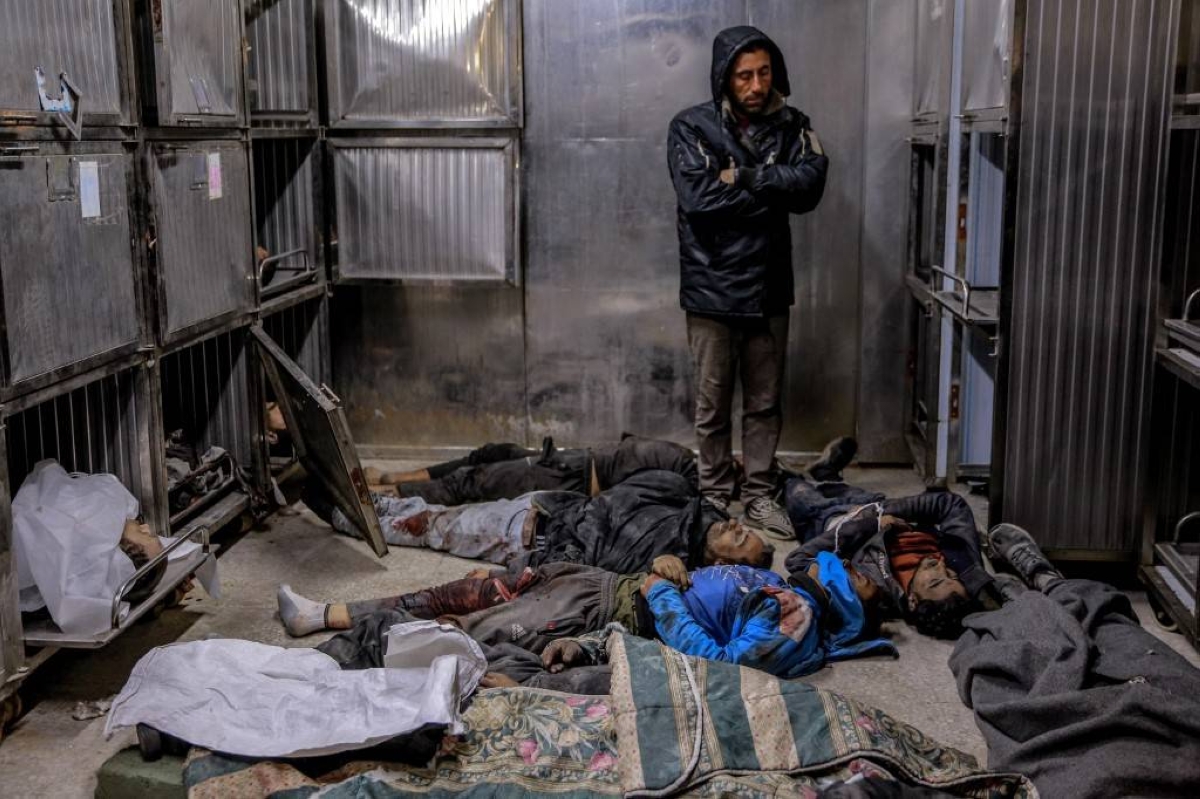 STILL ALIVE A man stands surrounded by the bodies of Palestinians killed in Israeli bombardment at the morgue of Al-Shifa Hospital in Gaza City, northern Gaza Strip on March 15, 2024. AFP PHOTO