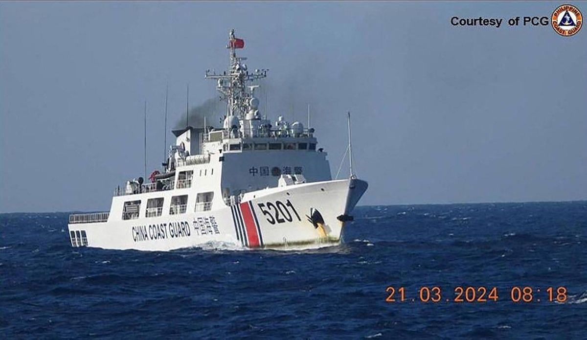 In this handout frame grab video footage taken on March 21, 2024 and received from Philippine Coast Guard (PCG) on March 22, shows a Chinese Coast Guard ship shadowing a Philippine Coast Guard ship (not pictured) near Sandy Cay reef, near the Philippine-held Thitu Island in Spratly Islands, in the disputed South China Sea. The Philippine Coast Guard on March 22 accused a Chinese vessel of 