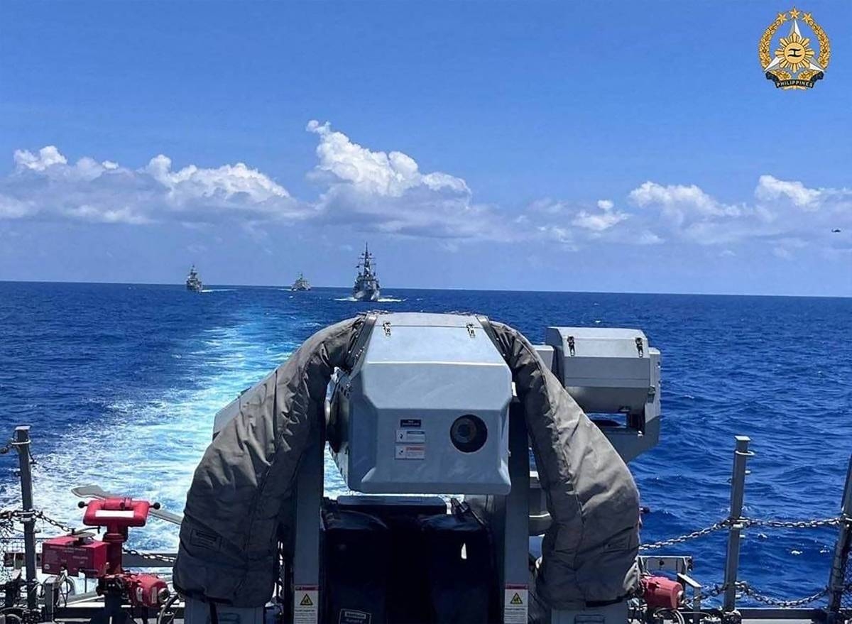 This handout photograph taken on April 7, 2024 and released by the Armed Forces of the Philippines (AFP), shows three vessels HMAS Warramunga, USS Mobile and JS Akebono as seen from the BRP Antonio Luna, conducting the division tactics exercise or Officer of the Watch maneuver during the first Multilateral Maritime Cooperative Activity between the Philippines, US, Australia and Japan, in South China Sea. AFP PHOTO /Armed Forces of the Philippines