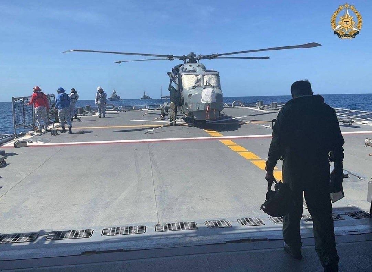 In this handout photo taken and received on April 7, 2024 from the Armed Forces of the Philippines (AFP), shows a Philippine Navy AW159 Wildcat helicopter pilot walking toward BRP Antonio Luna's helideck to conduct his pre-flight inspection procedure on the helicopter during the first Multilateral Maritime Cooperative Activity between the Philippines, US, Australia and Japan, in South China Sea. AFP PHOTO / Armed Forces of the Philippines 