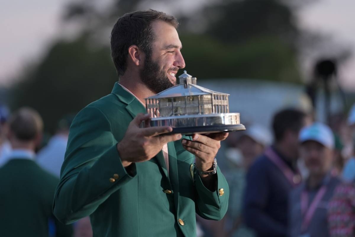 Scottie Scheffler holds the trophy after winning the Masters golf tournament at Augusta National Golf Club Sunday, April 14, 2024. AP PHOTO