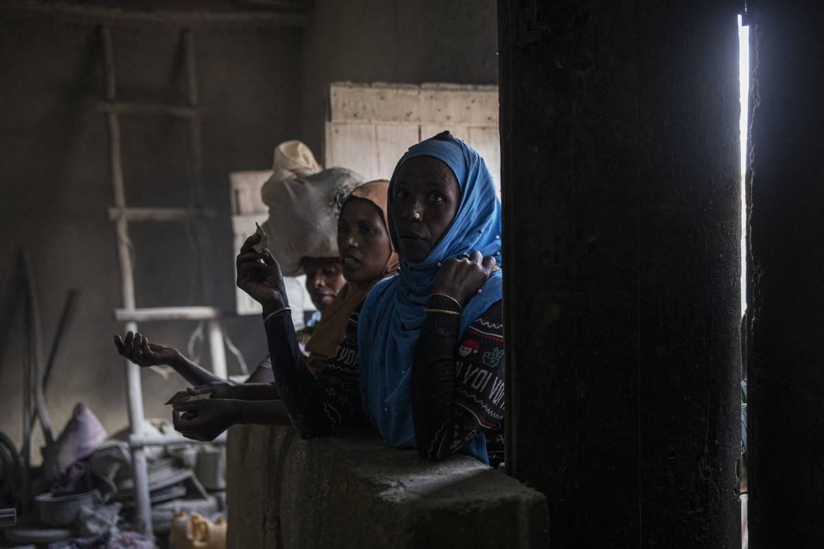 Women wait for their turn at a mill inside Harar walled city on April 15, 2024. AFP PHOTO