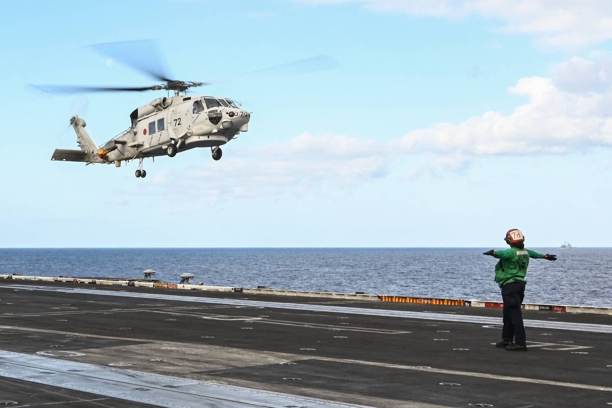This photo taken on January 31, 2024, shows a Japan Maritime Self-Defense Force SH-60K helicopter landing on the deck of the aircraft carrier USS Carl Vinson during a three-day US-Japan maritime exercise in the Philippine Sea.  PHOTO RICHARD A. BROOKS/AFP 