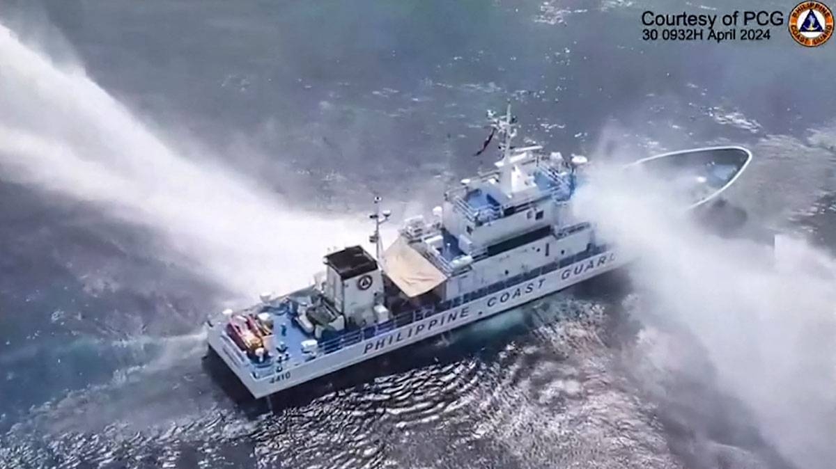 This frame grab from handout video footage taken and released on April 30, 2024 by the Philippine Coast Guard (PCG) shows the Philippine Coast Guard ship BRP Bagacay being hit by water cannon from Chinese coast guard vessels near the chinese-controlled Scarborough shoal in disputed waters of the South China Sea. The Philippines said the China Coast Guard fired water cannon on April 30 at two of its vessels, causing damage to one of them, during a patrol near a reef off the Southeast Asian country. Handout / Philippine Coast Guard (PCG) / AFP